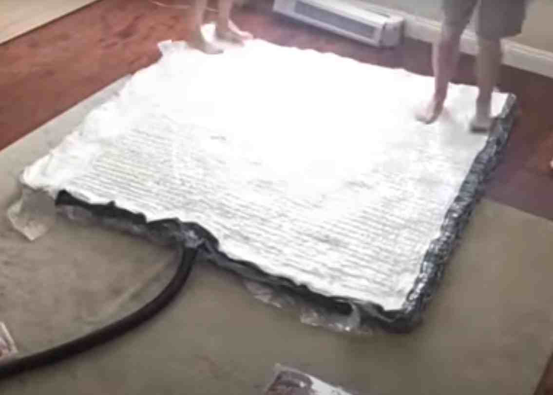 How do I put a mattress into a mattress bag and roll it up?